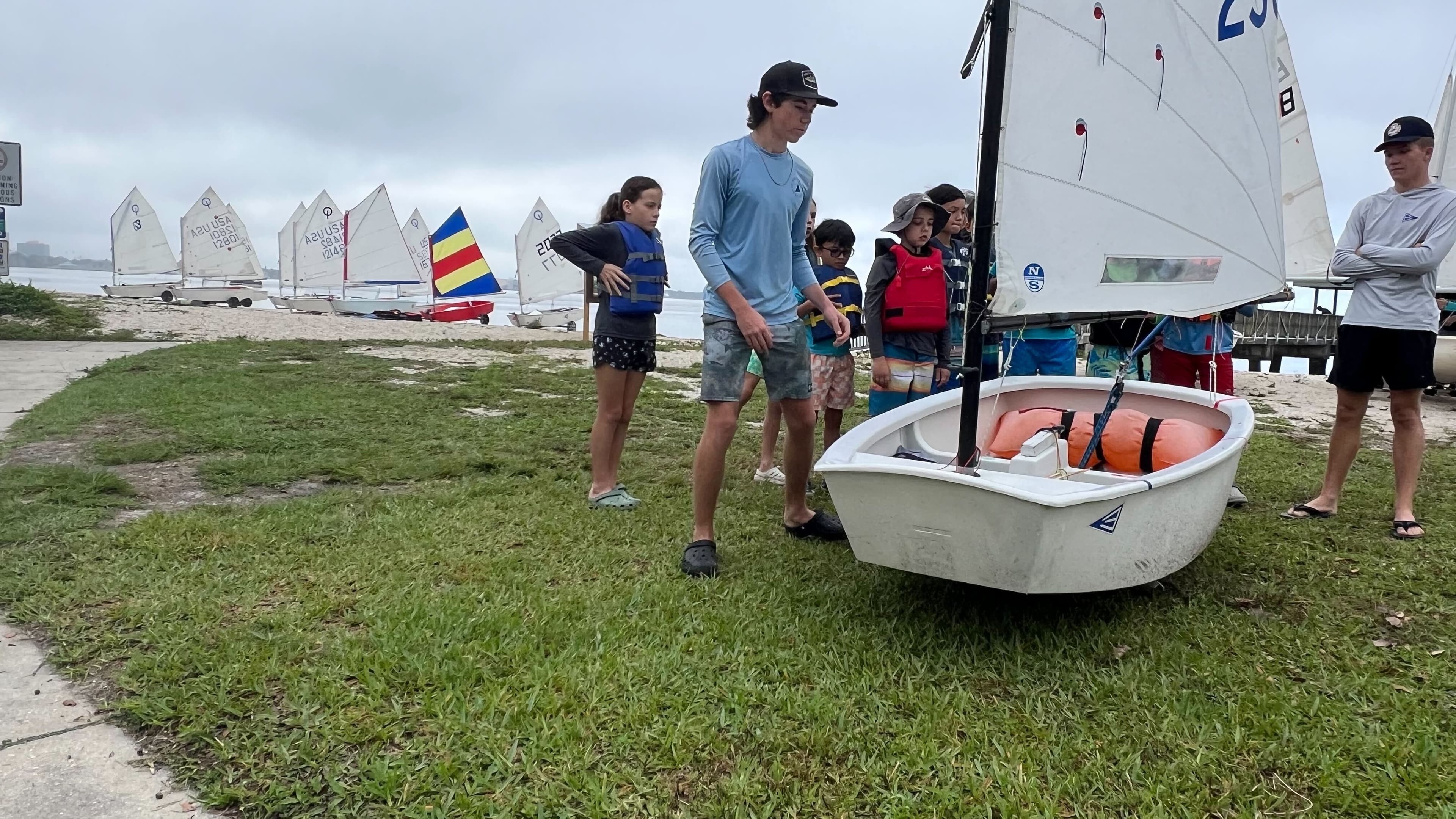 Instructor working with small group of sailors