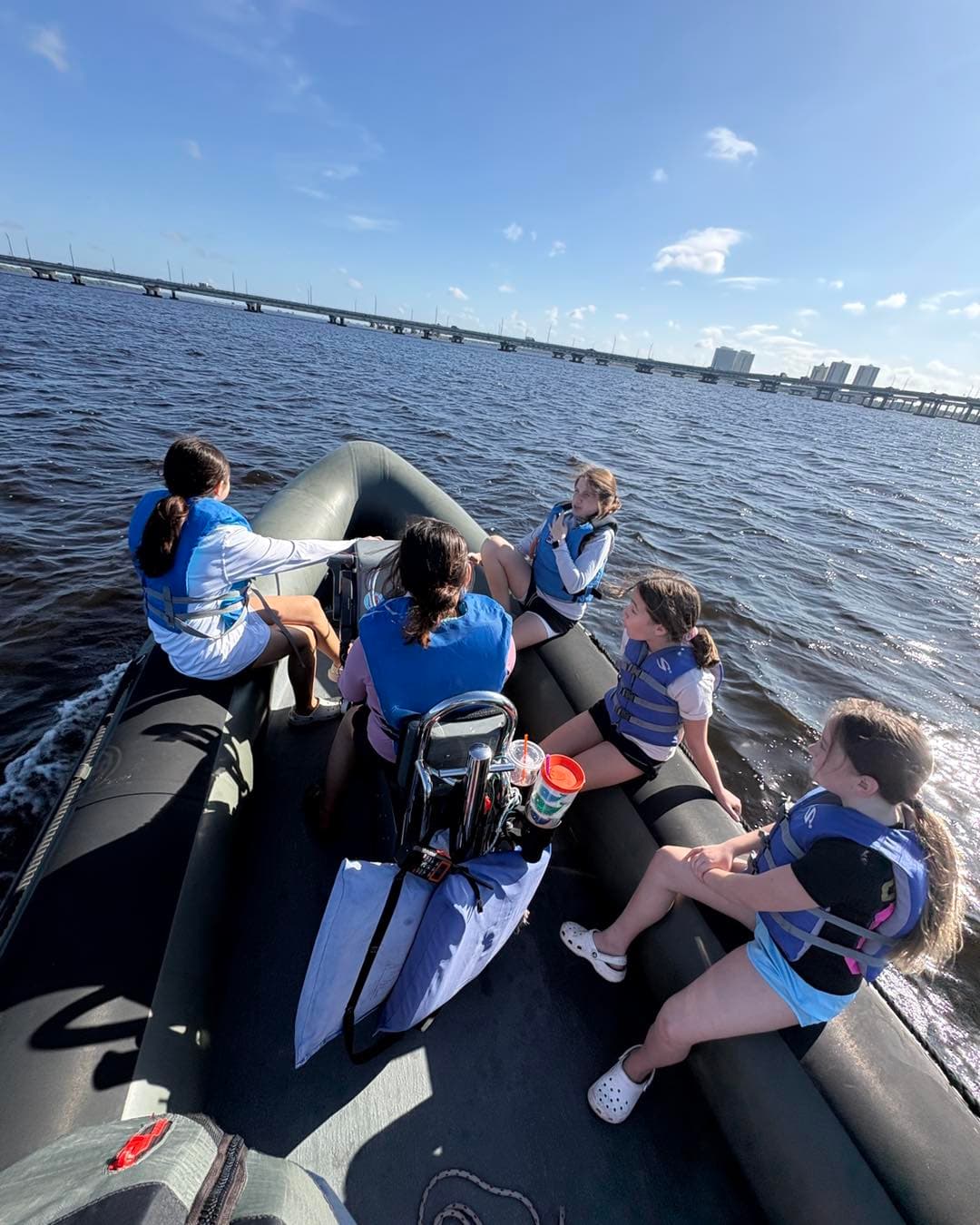 Kids in inflatable powerboat on the river