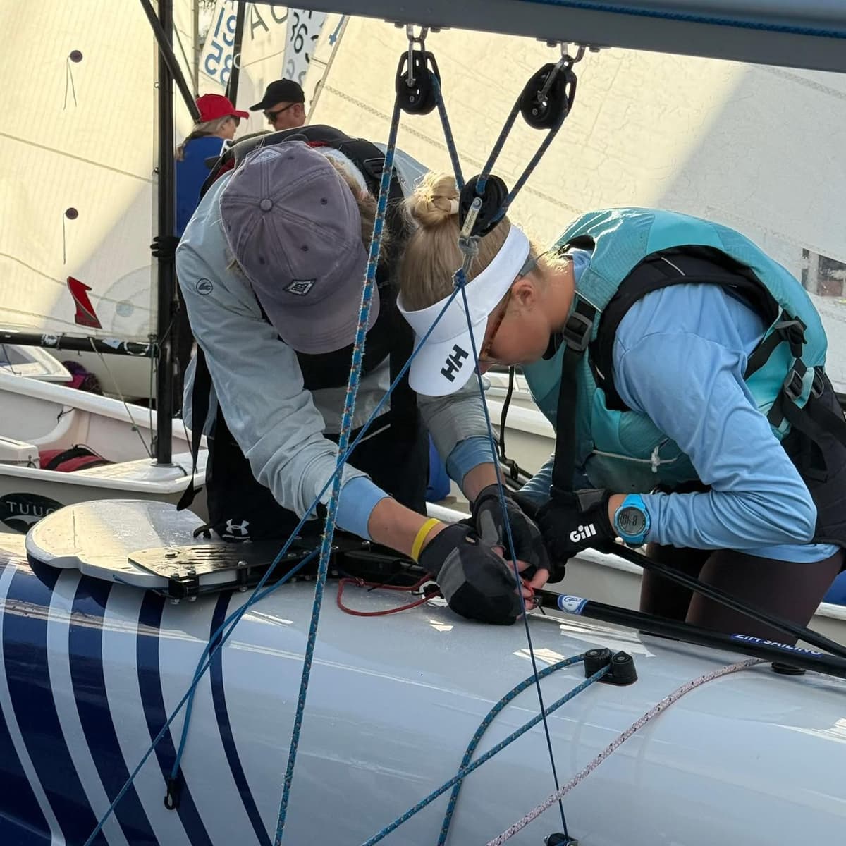 Sailors working together rigging a boat