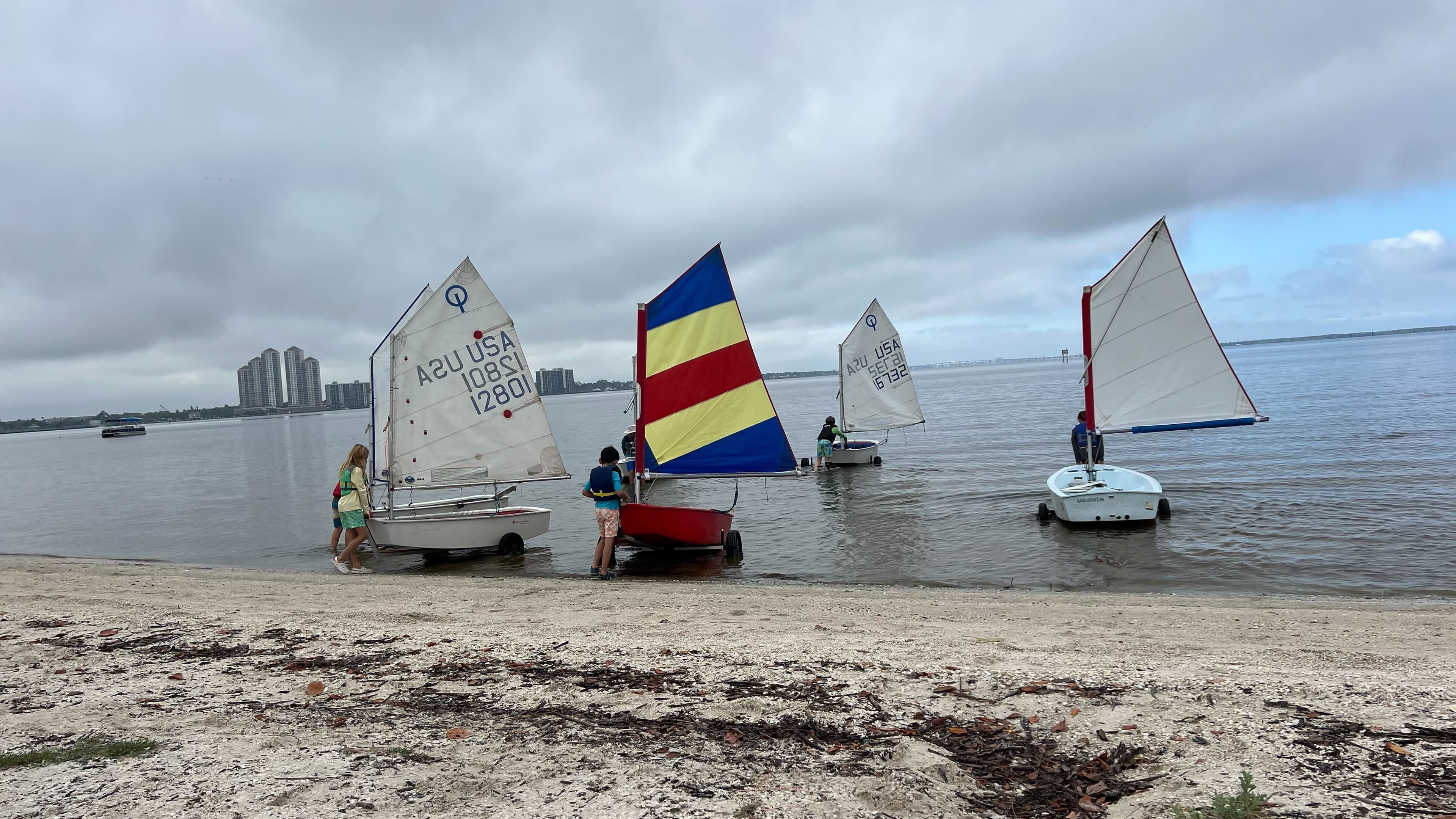 Fleet of sailboats launching into the water